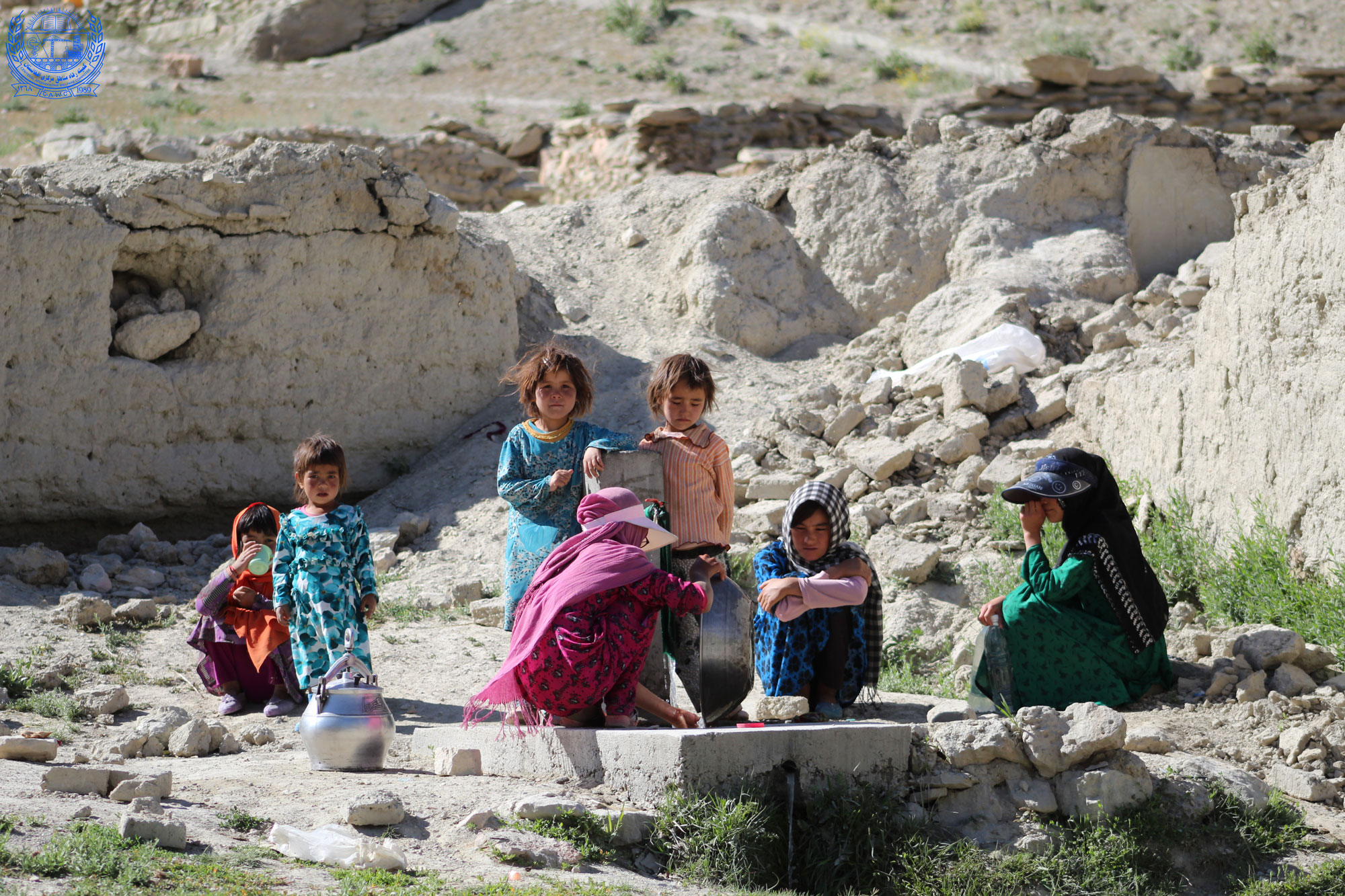 Young girls in Daikondi province using the water tap installed near their houses